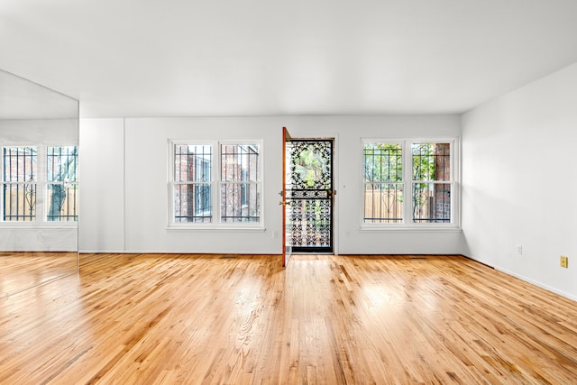 unfurnished room featuring light wood-type flooring