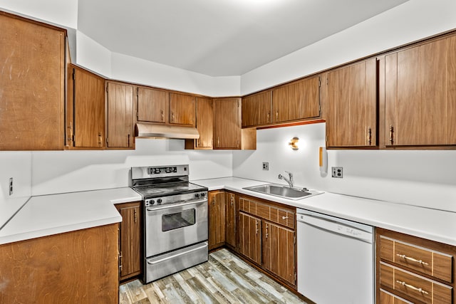 kitchen with dishwasher, sink, light wood-type flooring, and stainless steel range with electric cooktop