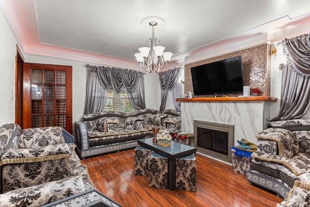 living room featuring a chandelier and wood-type flooring