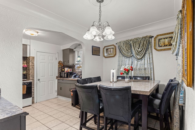 dining space featuring a notable chandelier and light tile patterned flooring