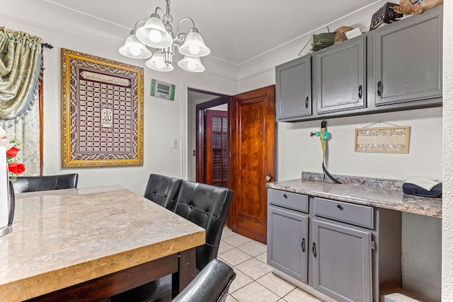 dining area featuring light tile patterned floors and a chandelier