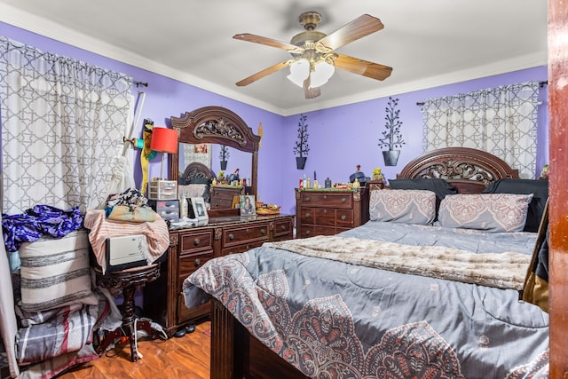 bedroom featuring light hardwood / wood-style flooring, ceiling fan, and ornamental molding