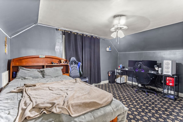 carpeted bedroom featuring vaulted ceiling and ceiling fan