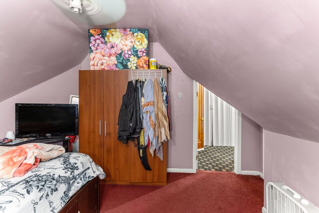 bedroom featuring carpet floors and vaulted ceiling