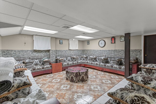 interior space featuring tile patterned floors and a paneled ceiling