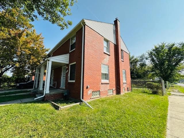 view of property exterior with covered porch and a yard