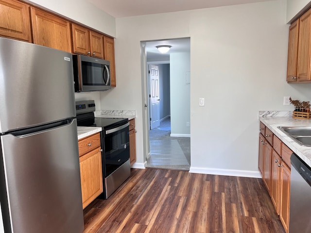 kitchen with sink, stainless steel appliances, and dark hardwood / wood-style floors