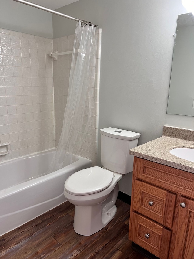 full bathroom with vanity, hardwood / wood-style flooring, toilet, and shower / bath combo with shower curtain