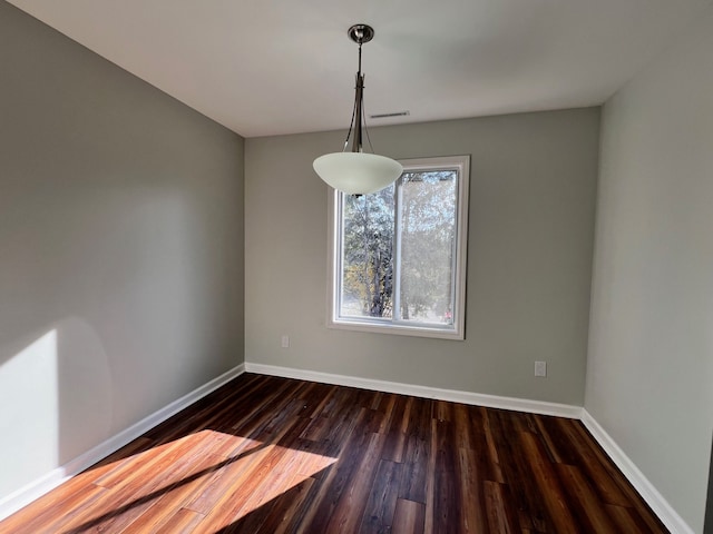 spare room with dark hardwood / wood-style floors