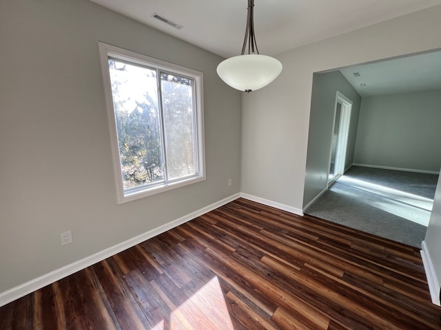 unfurnished dining area featuring dark wood-type flooring