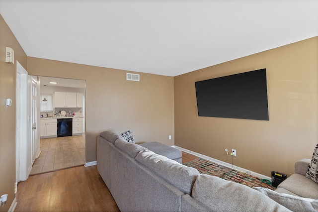 living room with light hardwood / wood-style flooring