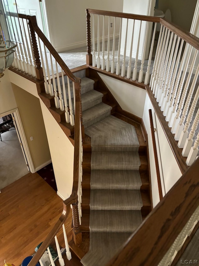 stairs with hardwood / wood-style flooring