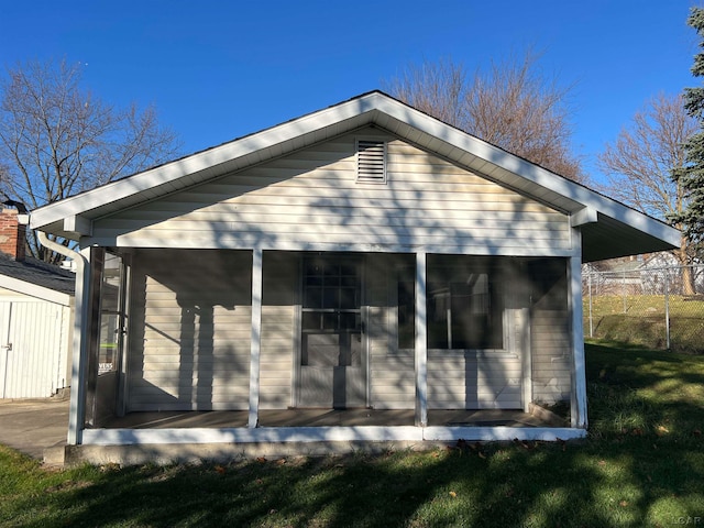 rear view of property with a yard