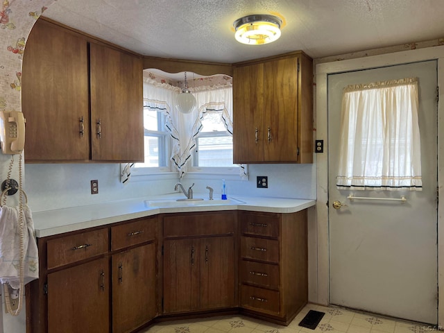 kitchen with sink and a textured ceiling