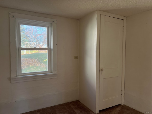 spare room featuring a textured ceiling