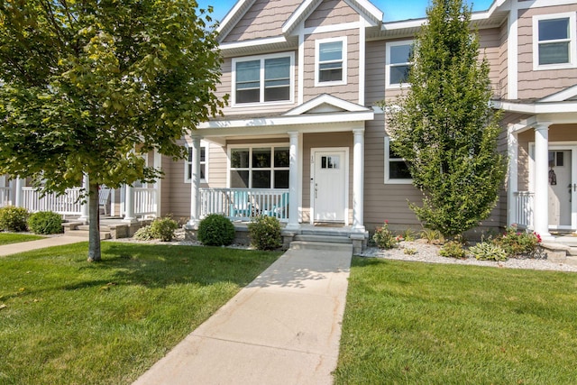 view of front of home featuring covered porch and a front lawn