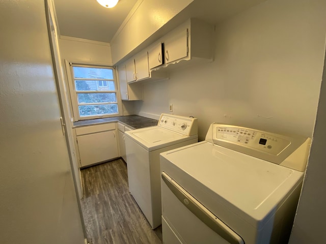 washroom with cabinets, washer and dryer, dark hardwood / wood-style floors, and ornamental molding