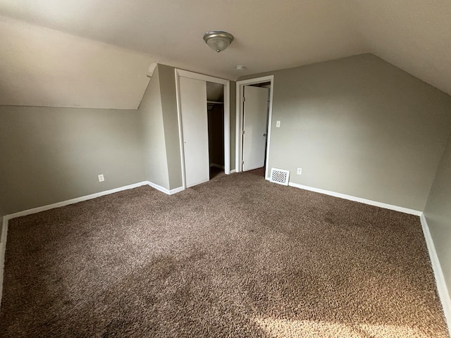 bonus room with carpet flooring and lofted ceiling