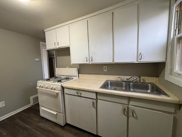 kitchen with dark hardwood / wood-style flooring, white cabinetry, gas range gas stove, and sink