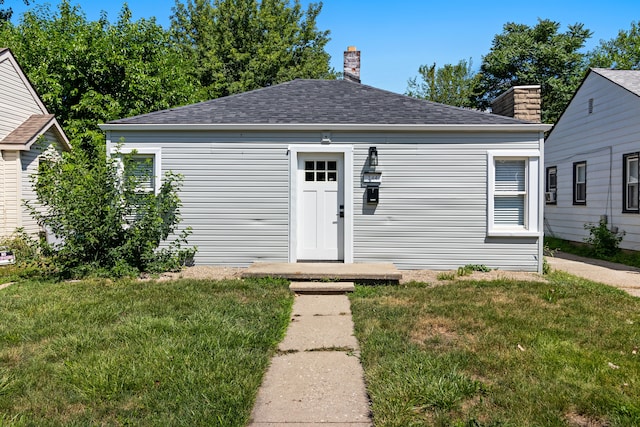 bungalow-style home with a front lawn