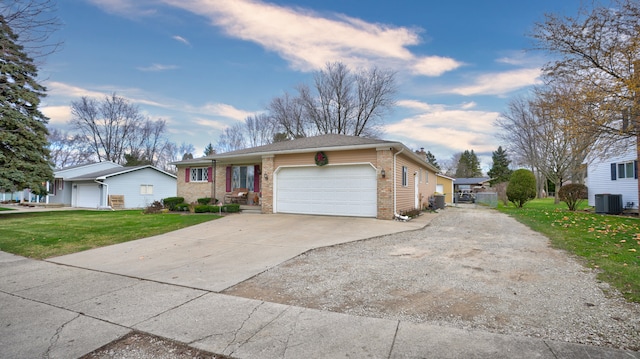 ranch-style house featuring cooling unit, a front yard, and a garage