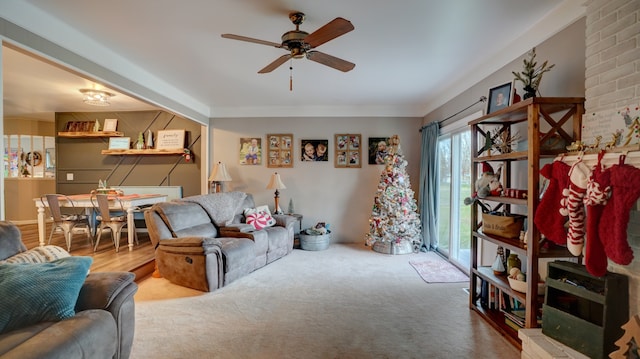 carpeted living room with ceiling fan