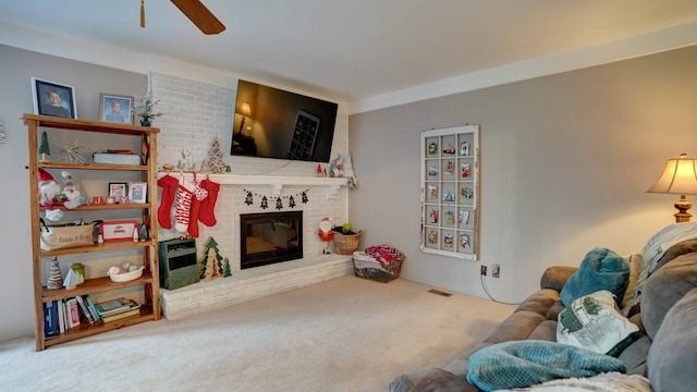 carpeted living room featuring ceiling fan and a fireplace