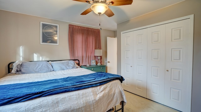 bedroom with light colored carpet, a closet, and ceiling fan