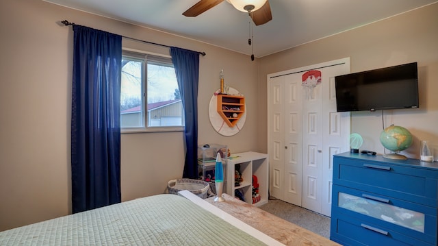 bedroom with light colored carpet, a closet, and ceiling fan