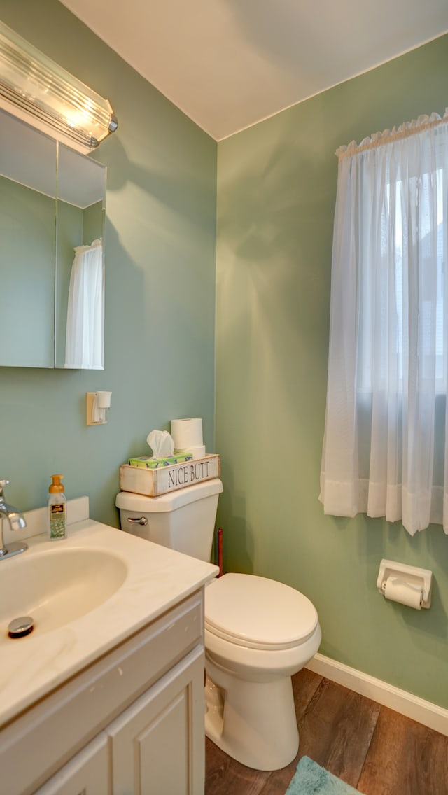 bathroom featuring hardwood / wood-style floors, vanity, and toilet