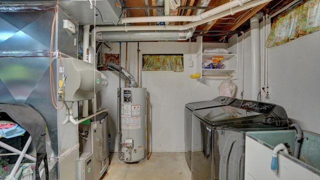 clothes washing area with washer and clothes dryer, heating unit, sink, and water heater