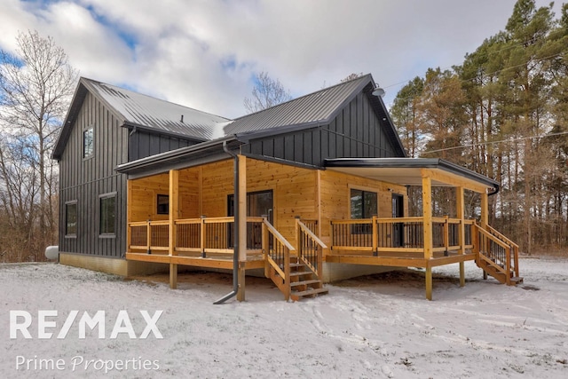 snow covered property with a porch