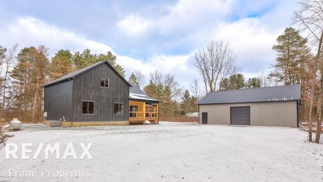 view of home's exterior featuring a garage, an outdoor structure, and central air condition unit