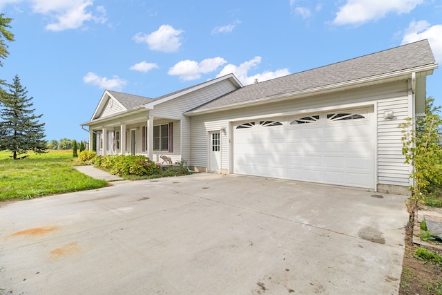 ranch-style house with a garage and a front lawn