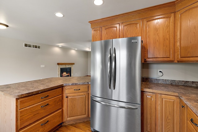 kitchen featuring stainless steel refrigerator and light wood-type flooring