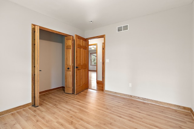 empty room with light hardwood / wood-style floors