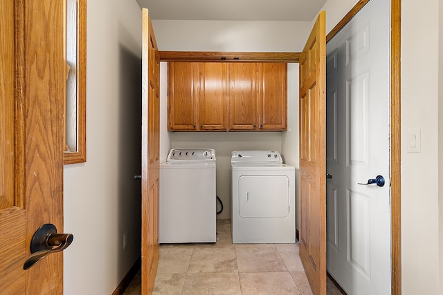 washroom with light tile patterned flooring, cabinets, and independent washer and dryer