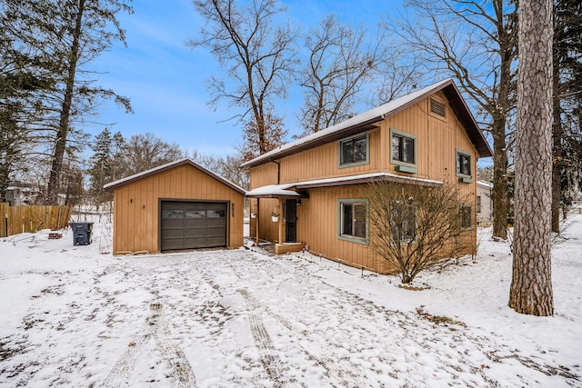 view of front of house with a garage and an outdoor structure