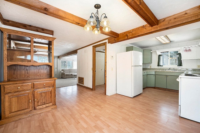 kitchen featuring decorative light fixtures, a chandelier, white appliances, and light wood-type flooring