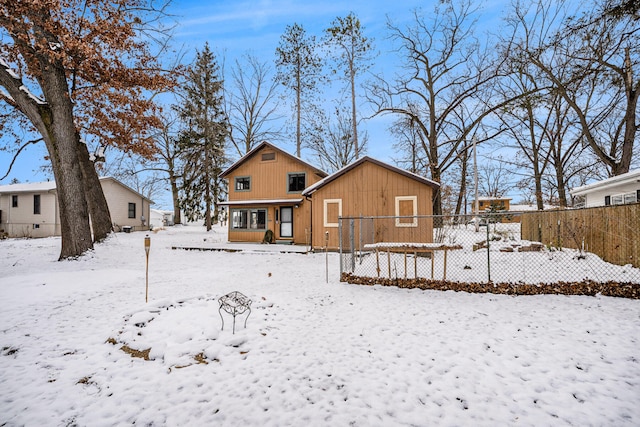 view of snow covered rear of property