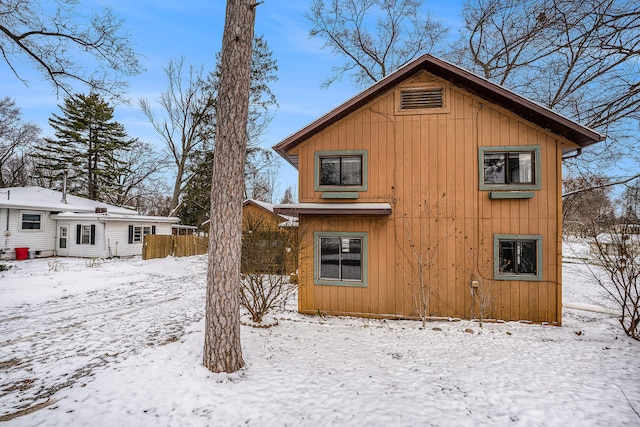 view of snow covered back of property