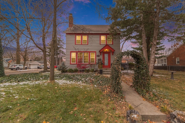 colonial inspired home featuring a yard