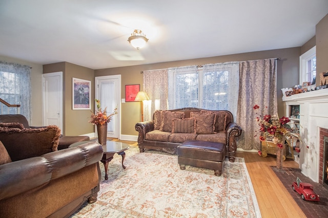 living room with a healthy amount of sunlight, light wood-type flooring, and a fireplace