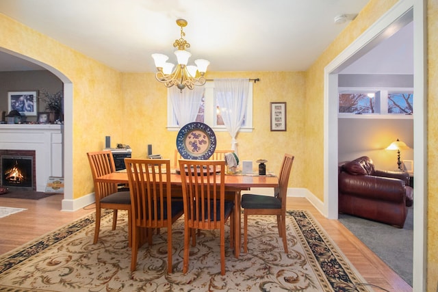 dining space with a chandelier and light hardwood / wood-style floors