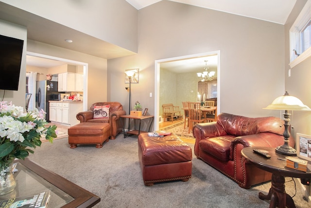 carpeted living room featuring a chandelier and a high ceiling