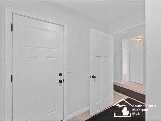 foyer entrance with light hardwood / wood-style floors