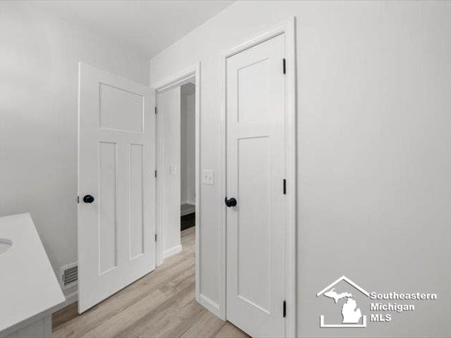 hallway with light hardwood / wood-style flooring