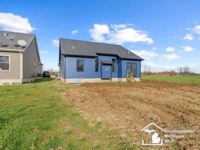 rear view of house with a yard