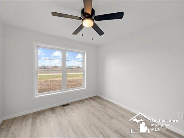 empty room featuring light hardwood / wood-style flooring and ceiling fan