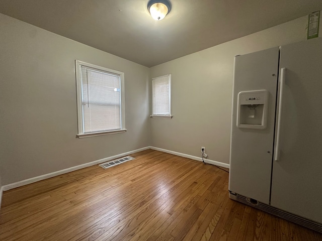 spare room with hardwood / wood-style flooring